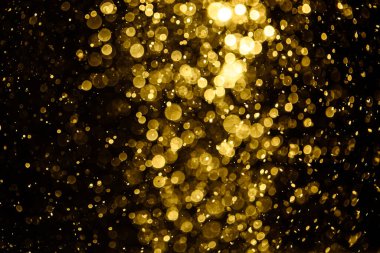 Görünür altın noktalı bulanık fotoğraf ışıl ışıl parlıyor. Duvar kağıdı olarak kullanılabilecek kadar lüks görünüyor.