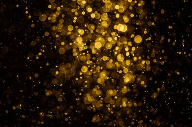 Görünür altın noktalı bulanık fotoğraf ışıl ışıl parlıyor. Duvar kağıdı olarak kullanılabilecek kadar lüks görünüyor.