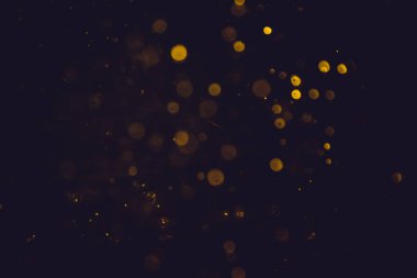 Altın bokeh, siyah arka planlı bulanık lüks