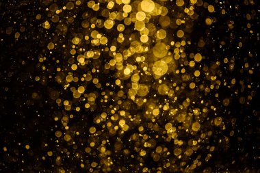 Görünür altın noktalı bulanık fotoğraf ışıl ışıl parlıyor. Duvar kağıdı olarak kullanılabilecek kadar lüks görünüyor.