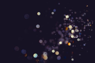 Defocus blur bokeh glitter gold vintage tone on black background clipart