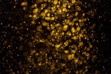 Görünür altın noktalı bulanık fotoğraf ışıl ışıl parlıyor. Duvar kağıdı olarak kullanılabilecek kadar lüks görünüyor.