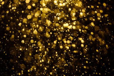 Görünür altın noktalı bulanık fotoğraf ışıl ışıl parlıyor. Duvar kağıdı olarak kullanılabilecek kadar lüks görünüyor.