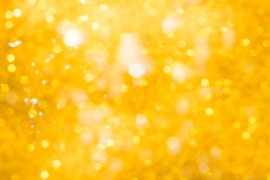 Altın soyut ışıltılar ya da parıltılı ışıklar Odaklanmamış daireler bokeh arkaplanı