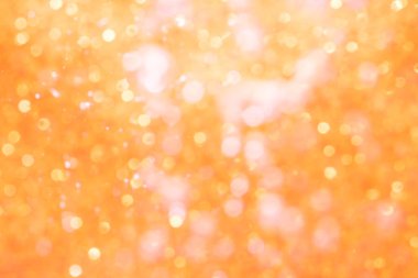 Turuncu soyut ışıltılar ya da parıltılı ışıklar Odaklanmamış daireler bokeh arkaplanı