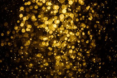 Görünür altın noktalı bulanık fotoğraf ışıl ışıl parlıyor. Duvar kağıdı olarak kullanılabilecek kadar lüks görünüyor.