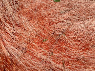 Macro view of tangled copper wire shavings forming a dense mesh. clipart