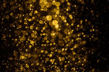 Görünür altın noktalı bulanık fotoğraf ışıl ışıl parlıyor. Duvar kağıdı olarak kullanılabilecek kadar lüks görünüyor.