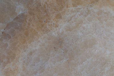 A close-up photo of the cream-colored stone, showing the details of the stone texture. clipart