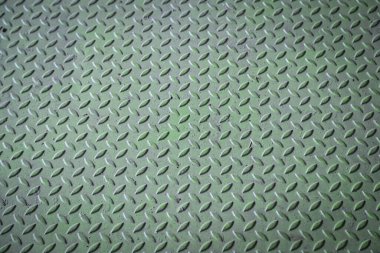 Green diamond plate metal surface with visible wear and scratches clipart