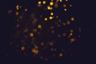 Altın bokeh, siyah arka planlı bulanık lüks