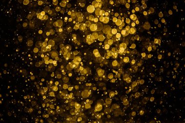 Görünür altın noktalı bulanık fotoğraf ışıl ışıl parlıyor. Duvar kağıdı olarak kullanılabilecek kadar lüks görünüyor.