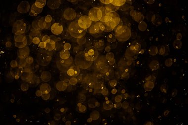 Görünür altın noktalı bulanık fotoğraf ışıl ışıl parlıyor. Duvar kağıdı olarak kullanılabilecek kadar lüks görünüyor.