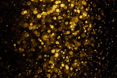 Görünür altın noktalı bulanık fotoğraf ışıl ışıl parlıyor. Duvar kağıdı olarak kullanılabilecek kadar lüks görünüyor.