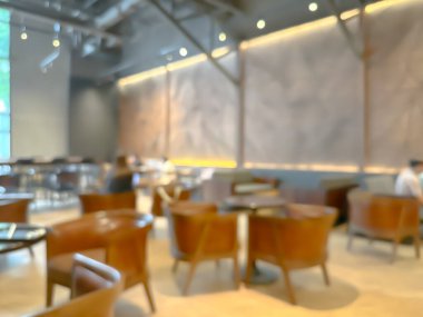 Ahşap sandalyeli, masalı, sıcak ışıklandırmalı ve büyük pencereli modern bir kafe.