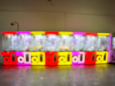 A row of colorful arcade game machines brightly illuminated in a dimly lit room, creating an exciting and nostalgic atmosphere. clipart