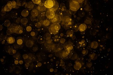 Görünür altın noktalı bulanık fotoğraf ışıl ışıl parlıyor. Duvar kağıdı olarak kullanılabilecek kadar lüks görünüyor.