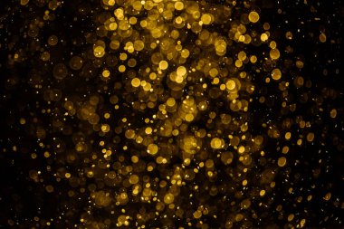 Görünür altın noktalı bulanık fotoğraf ışıl ışıl parlıyor. Duvar kağıdı olarak kullanılabilecek kadar lüks görünüyor.