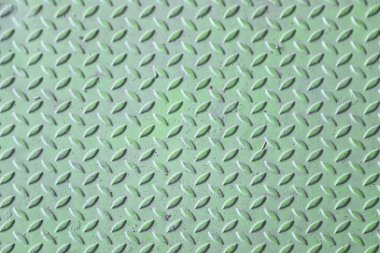 Green diamond plate metal surface with visible wear and scratches clipart