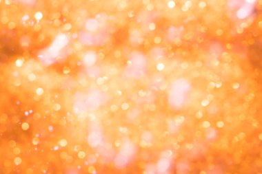 Turuncu soyut ışıltılar ya da parıltılı ışıklar Odaklanmamış daireler bokeh arkaplanı