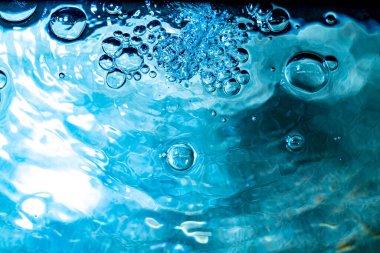 Su baloncukları havuzun arka planında soyut bokeh ışığı oluşturur.