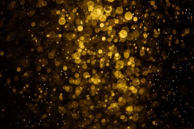 Görünür altın noktalı bulanık fotoğraf ışıl ışıl parlıyor. Duvar kağıdı olarak kullanılabilecek kadar lüks görünüyor.