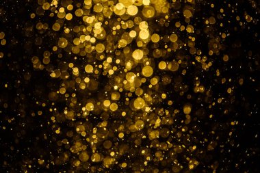 Görünür altın noktalı bulanık fotoğraf ışıl ışıl parlıyor. Duvar kağıdı olarak kullanılabilecek kadar lüks görünüyor.