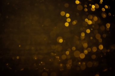 Görünür altın noktalı bulanık fotoğraf ışıl ışıl parlıyor. Lüks ve zevki gösteren bir duvar kağıdı olarak kullanılabilecek kadar lüks görünüyor..