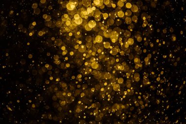 Görünür altın noktalı bulanık fotoğraf ışıl ışıl parlıyor. Duvar kağıdı olarak kullanılabilecek kadar lüks görünüyor.