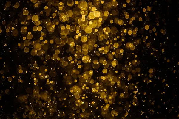 Görünür altın noktalı bulanık fotoğraf ışıl ışıl parlıyor. Duvar kağıdı olarak kullanılabilecek kadar lüks görünüyor.