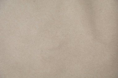 Kahverengi bir Kraft kağıt dokusunun yüksek çözünürlüklü yakın çekimi, doğal ve biraz pürüzlü bir yüzeyi var. Arkaplan olarak kullanmak için ideal