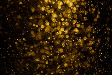 Görünür altın noktalı bulanık fotoğraf ışıl ışıl parlıyor. Duvar kağıdı olarak kullanılabilecek kadar lüks görünüyor.