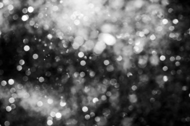 Siyah soyut ışıltılar ya da parıltılı ışıklar Odaklanmış daireler bokeh arkaplanı
