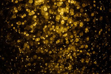 Görünür altın noktalı bulanık fotoğraf ışıl ışıl parlıyor. Duvar kağıdı olarak kullanılabilecek kadar lüks görünüyor.