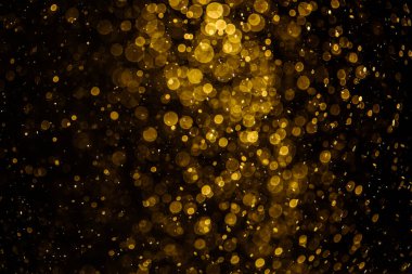 Görünür altın noktalı bulanık fotoğraf ışıl ışıl parlıyor. Duvar kağıdı olarak kullanılabilecek kadar lüks görünüyor.