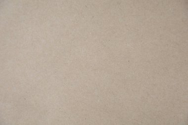 Kahverengi bir Kraft kağıt dokusunun yüksek çözünürlüklü yakın çekimi, doğal ve biraz pürüzlü bir yüzeyi var. Arkaplan olarak kullanmak için ideal