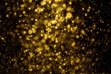 Görünür altın noktalı bulanık fotoğraf ışıl ışıl parlıyor. Duvar kağıdı olarak kullanılabilecek kadar lüks görünüyor.