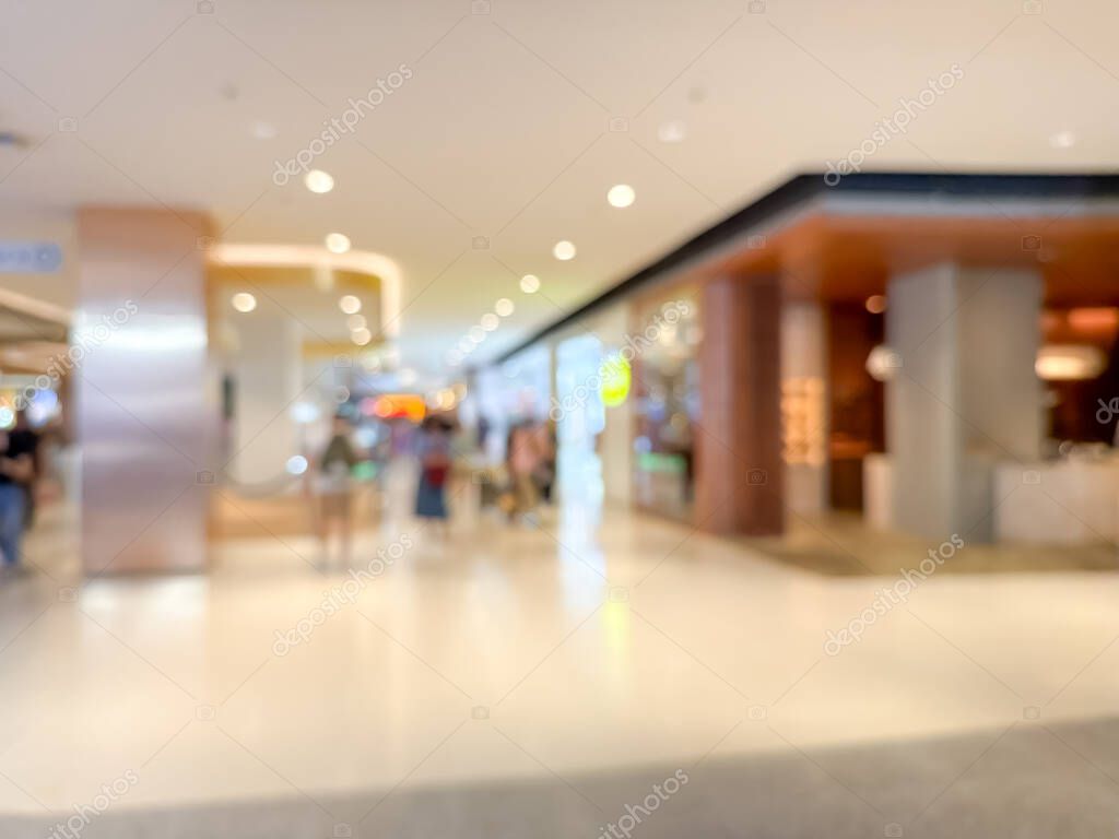 Blurred image of a bustling shopping mall, capturing the vibrant atmosphere of a modern retail environment. People are seen shopping