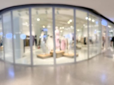 Hareketli bir alışveriş merkezinin bulanık görüntüsü modern bir perakende satış ortamının canlı atmosferini yakalıyor. İnsanlar alışveriş yaparken görülüyor.