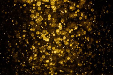 Görünür altın noktalı bulanık fotoğraf ışıl ışıl parlıyor. Duvar kağıdı olarak kullanılabilecek kadar lüks görünüyor.