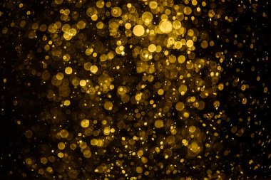 Görünür altın noktalı bulanık fotoğraf ışıl ışıl parlıyor. Duvar kağıdı olarak kullanılabilecek kadar lüks görünüyor.