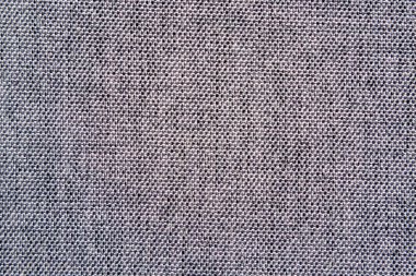 Sıkıca dokunmuş mavi bir kumaşın yakın plan görüntüsü, üniforma dokusunu ve ince iplik rengi varyasyonlarını gözler önüne seriyor. Arka planlar için ideal.