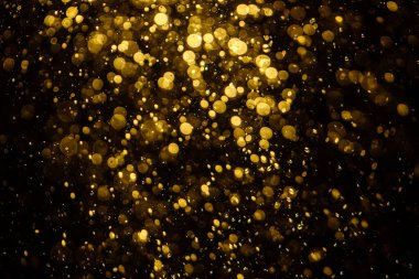 Görünür altın noktalı bulanık fotoğraf ışıl ışıl parlıyor. Duvar kağıdı olarak kullanılabilecek kadar lüks görünüyor.