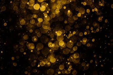 Görünür altın noktalı bulanık fotoğraf ışıl ışıl parlıyor. Duvar kağıdı olarak kullanılabilecek kadar lüks görünüyor.