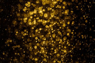 Görünür altın noktalı bulanık fotoğraf ışıl ışıl parlıyor. Duvar kağıdı olarak kullanılabilecek kadar lüks görünüyor.