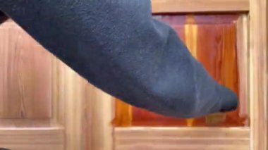 Ahşap kapı yüzeyinde fırça ile şeffaf ahşap koruyucu uygulama, ahşap yağlama zaman aşımı, önce ve sonra. 