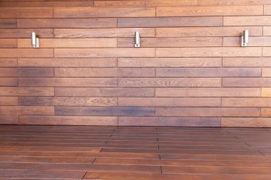 Termal olarak modifiye edilmiş ahşap, İskandinav termokül kaplaması. Geniş bir kapalı alanda, pürüzsüz kalasları ve modern gümüş aksesuarları olan güzel bir ahşap duvar bulunur. Sıcak melodiler samimi, davetkar bir atmosfer yaratıyor..