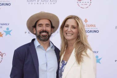 Studio City, CA - June 15, 2024: Chris Gialanella, publisher of Los Angeles Magazine and his wife, Andrea Gialanella attend the Ed Asner Celebrity Poker to Benefit Autism research.