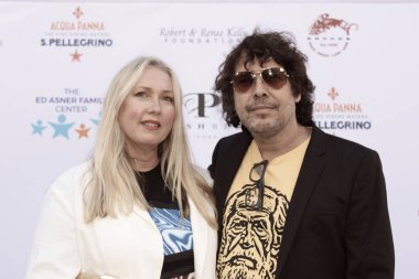 Studio City, CA - June 15, 2024: Kristin and Salvador Paskowitz attend the Ed Asner Celebrity Poker to Benefit Autism research.