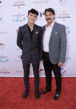 Studio City, CA - June 15, 2024: Johnny Dowers and Elijah Dowers attend the Ed Asner Celebrity Poker to Benefit Autism research.